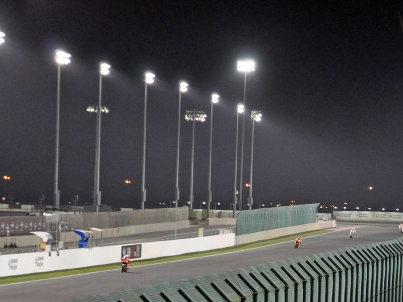 Motorcycles racing under floodlights at Lusail International Circuit during the 2010 Qatar motorcycle Grand Prix