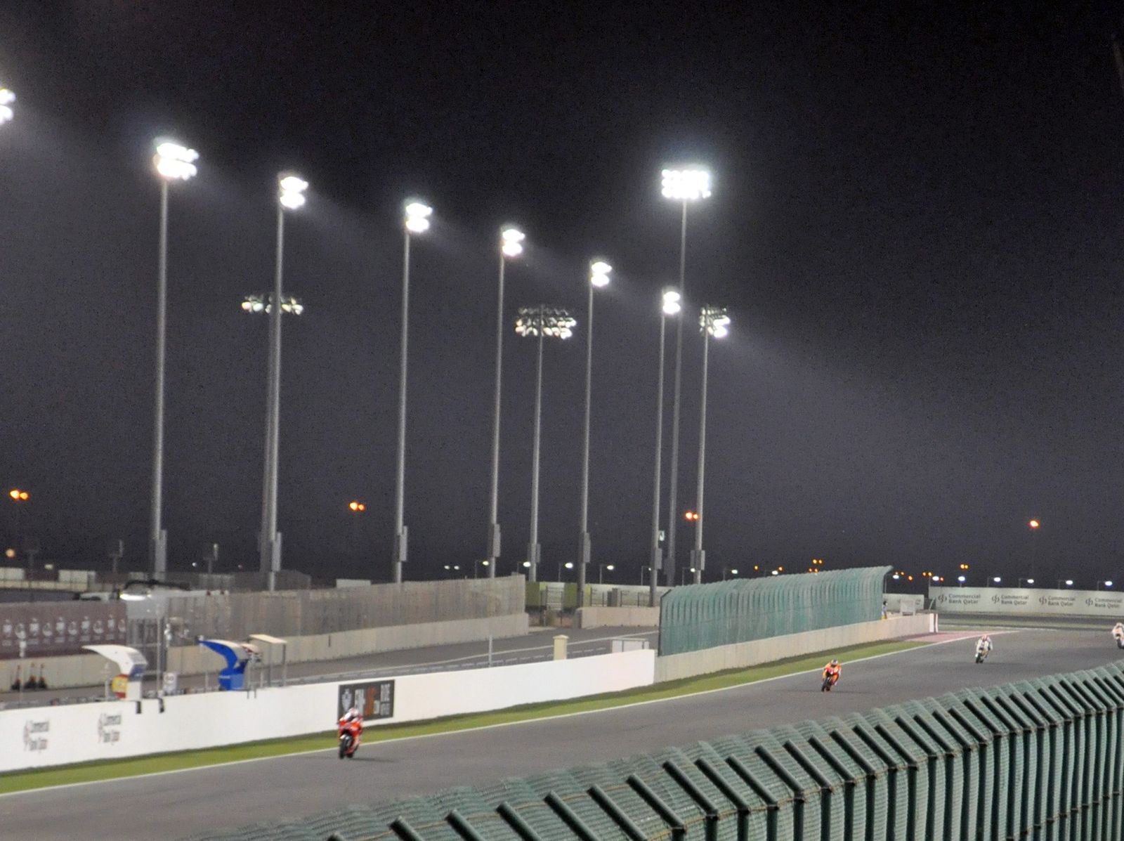 Motorcycles racing under floodlights at Lusail International Circuit during the 2010 Qatar motorcycle Grand Prix